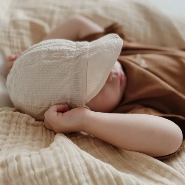 Baby trägt Strandhut Fina Sand 1