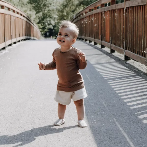 Baby trägt Shorts Alda Sand 1